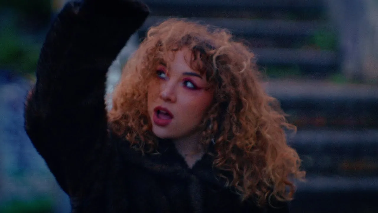 Julia Sabaté at dusk in a fur coat.