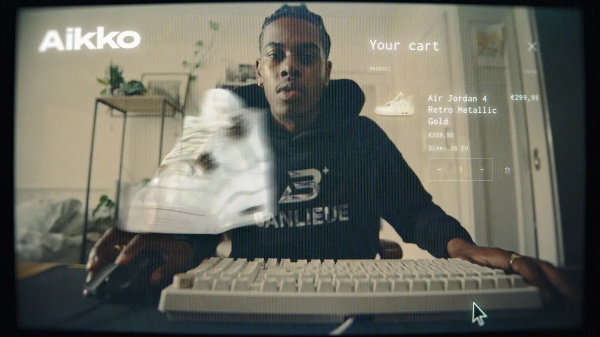Still from the Kyaro ad: a model with a keyboard and a Nike Air Jordan.